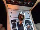a close up of a car ' s gear knob and controls