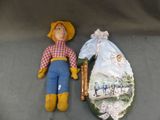 a doll that is laying on the ground next to a picture of a man
