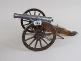 a toy cannon sitting on top of a wooden cart