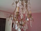 a chandelier hanging from the ceiling in a pink room