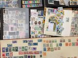 a lot of stamps on a table with a book