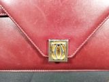 red leather purse with a gold clasp on the front