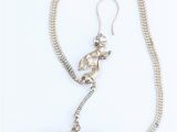 silver plated necklace and earrings with a horse on a chain