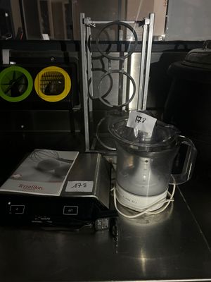 stainless steel counter top with a blender and other items on it