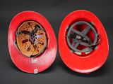 pair of red fire helmets on a black background with a black background
