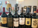 many bottles of wine sitting on a wooden tray