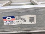a metal box with a label on it sitting on the ground