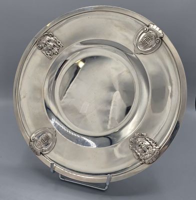 two silver plate with lion heads on each side and a silver plate with lion heads on the other side