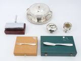 a silver plate and silverware on a white table