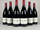 six bottles of red wine lined up in a row