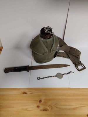 a knife, a bottle opener, and a pair of scissors on a table