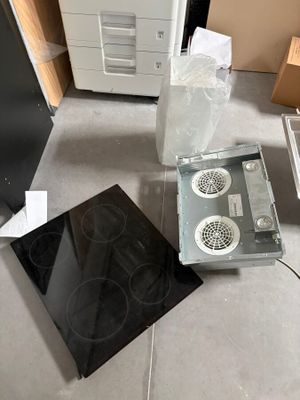 a stove and a microwave sitting on the floor in a room