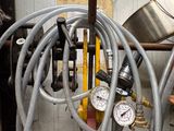 hoses and gauges are attached to the side of a fire hydrant in a garage