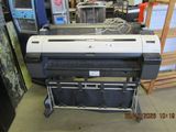 a large printer sitting on a cart in a warehouse