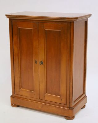a small wooden cabinet with a door on top of it