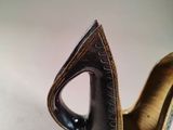 a brown and black vase on a white table