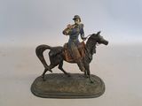 figurine of a man on a horse on a white background