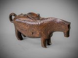 an elephant figurine made of wood with a saddle on it ' s back