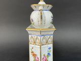 an image of a white and blue vase with flowers on it
