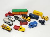 a lot of toy cars and trucks on a white surface