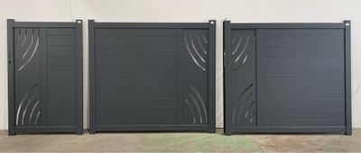a couple of black gates sitting next to each other on top of a cement floor