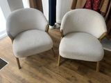 two chairs sitting next to each other on a wooden floor