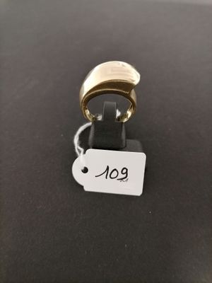 a close up of a gold ring with a tag on it