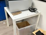 a white desk with a printer on top of it
