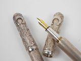 two pens sitting next to each other on a table