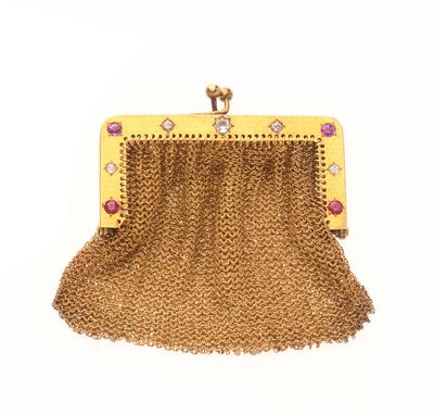un sac à main en chaîne dorée orné de pierres roses