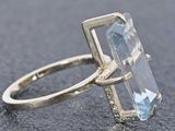 an image of a ring with a blue topaz stone in it