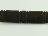a small wooden object that is on a white surface
