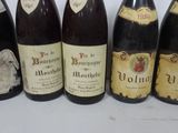 several bottles of wine are lined up on a table