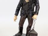 statue of a man with a backpack on his back