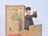 a figurine of a man standing in front of a box
