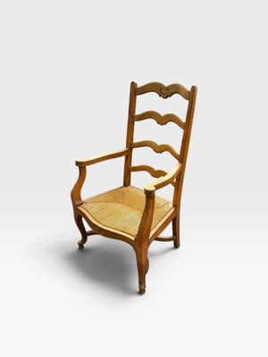 a wooden chair with a cane back and a cane seat