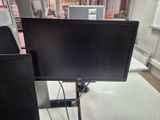 two monitors sitting on a stand in a room