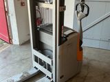 a fork lift truck that is parked in a garage