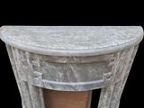 a marble table with a vase on top of it