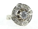 an image of a diamond ring with a center stone surrounded by diamonds
