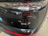 the rear end of a black car with a sticker on it ' s bumper