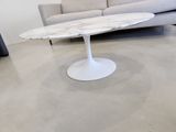a marble table with a white base in a living room