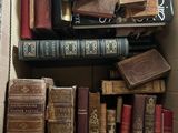 a box full of old books sitting on the floor