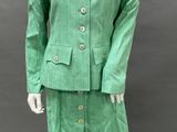 an image of a mannequin wearing a green suit and hat
