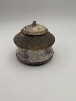 an old wooden box with a lid on a white surface