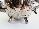 a silver tea pot that is sitting on a table