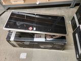 two laptops sitting on top of each other on the floor