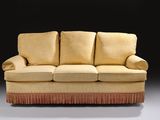 an image of a couch with a red fringe on it