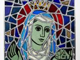 stained glass of the virgin of guadalupe with a crown on her head