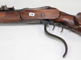 an old rifle with a wooden barrel and a metal trigger
